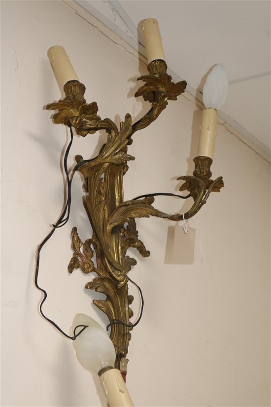 A pair of three branch ormolu wall lights length 55cm